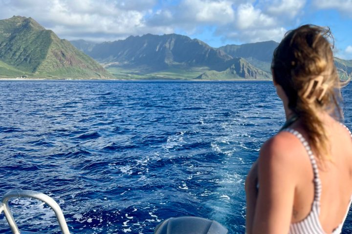 a woman standing in front of a body of water